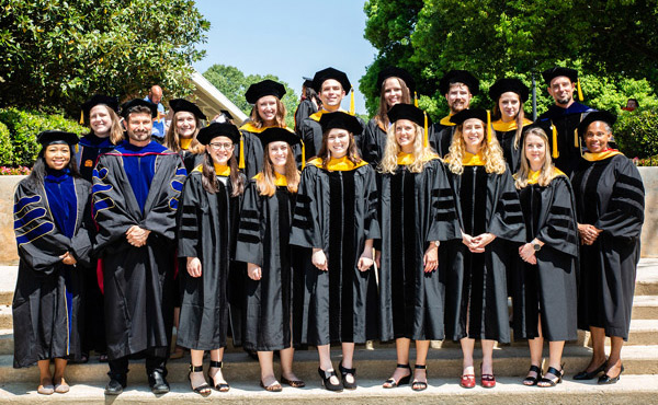 A group of graduates standing on steps