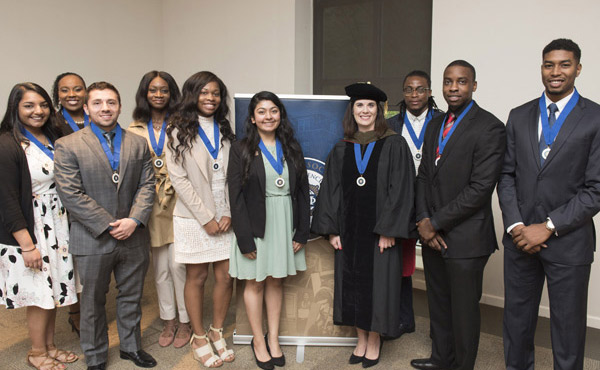 A group of ten people wearing medals