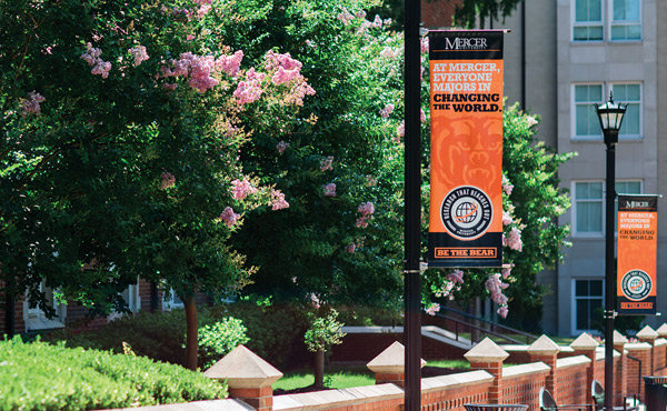 Mercer sidewalk banners that read "At Mercer, everyone majors in changing the world. Be the Bear"