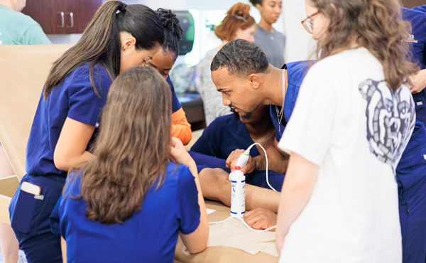 Occupational therapy students learning in the lab